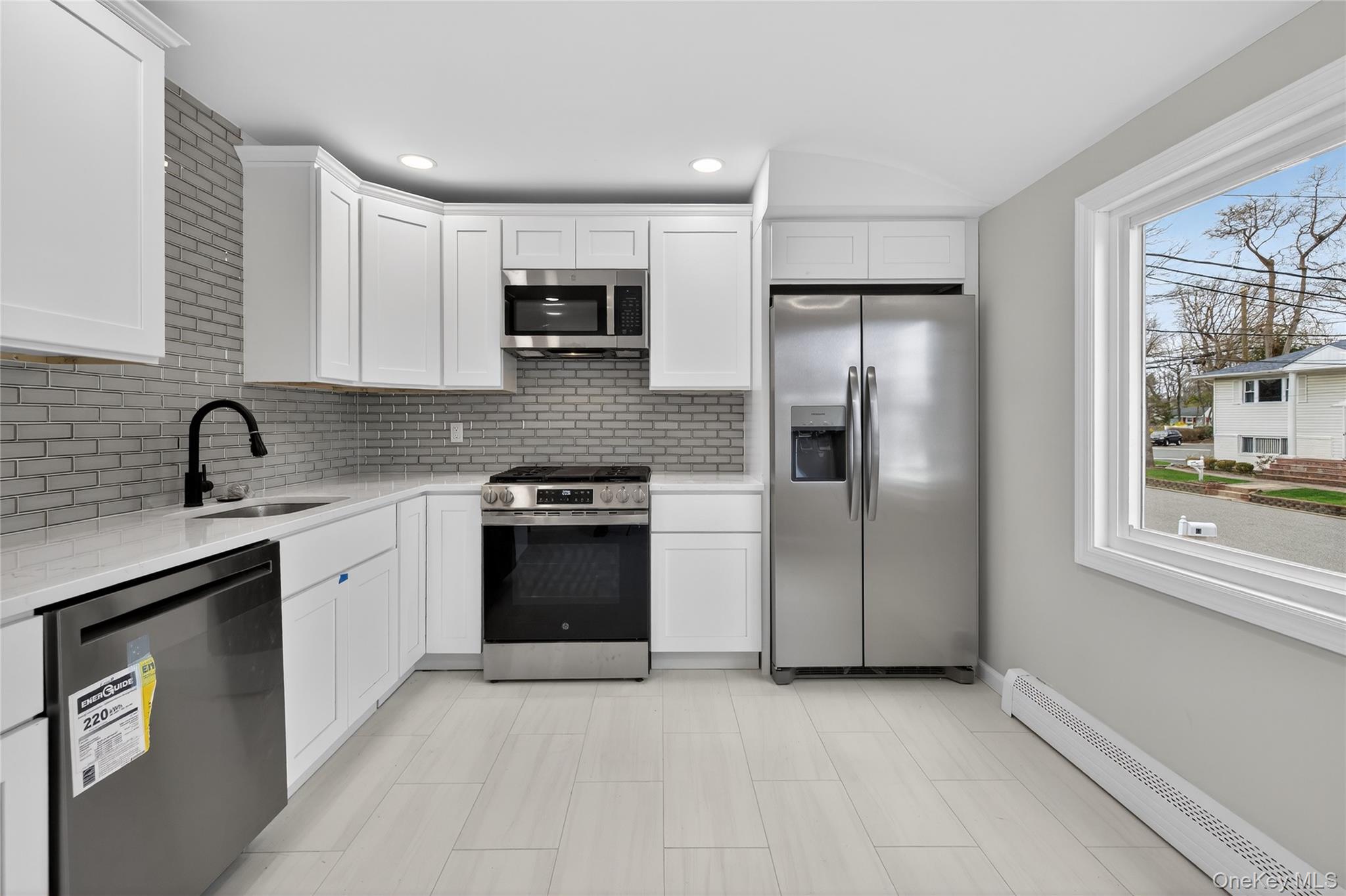 15 Lindsay Street Huntington, NY 11743 - Photo 11 of 23 a kitchen with stainless steel appliances granite countertop a refrigerator sink and stove