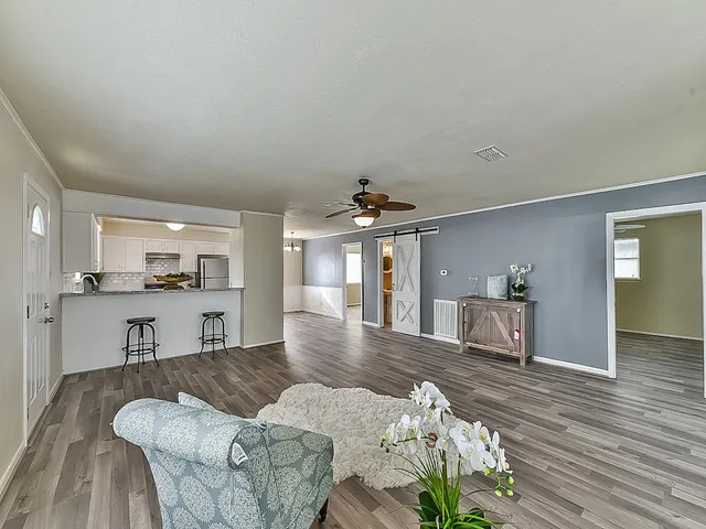 a living room with furniture and a wooden floor