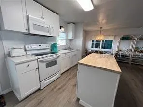 a living room with furniture a flat screen tv and a large window