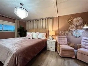 a bedroom with a large bed and a window