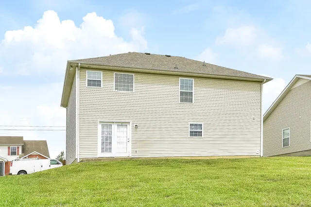 a front view of a house with a garden and yard