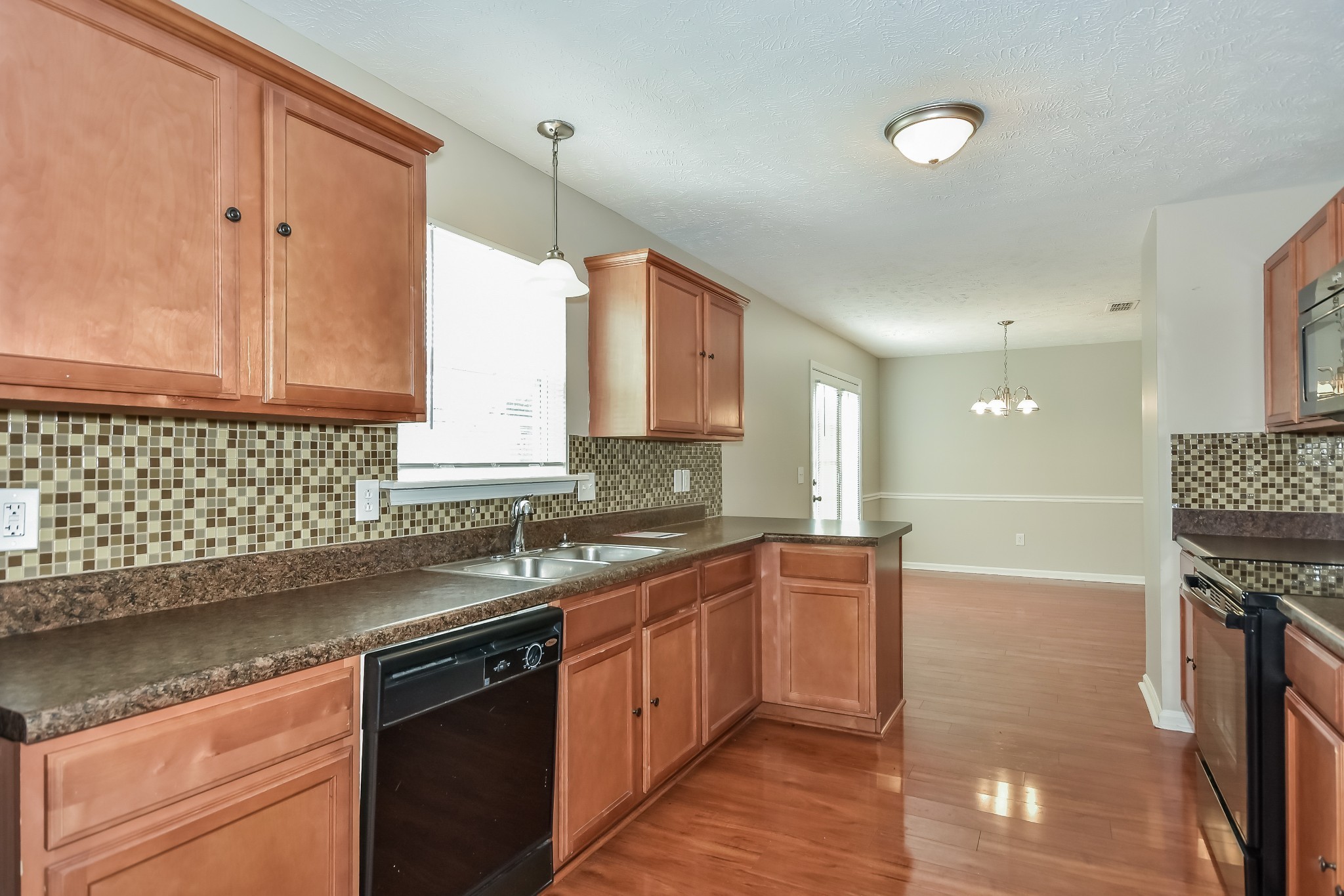 1224 Maritime Port Antioch, TN 37013 - Photo 6 of 17 a kitchen with stainless steel appliances granite countertop a sink a stove and a microwave