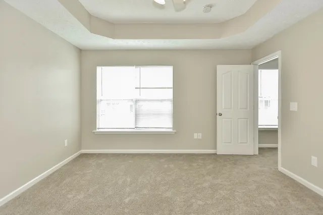 an empty room with windows and closet