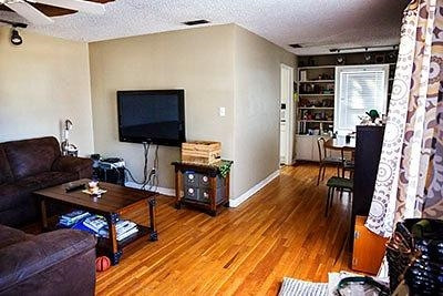 3319 26th Street Lubbock, TX 79410 - Photo 2 of 8 a living room with furniture and a flat screen tv
