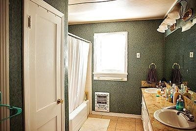 3319 26th Street Lubbock, TX 79410 - Photo 7 of 8 a bathroom with a sink a toilet and shower