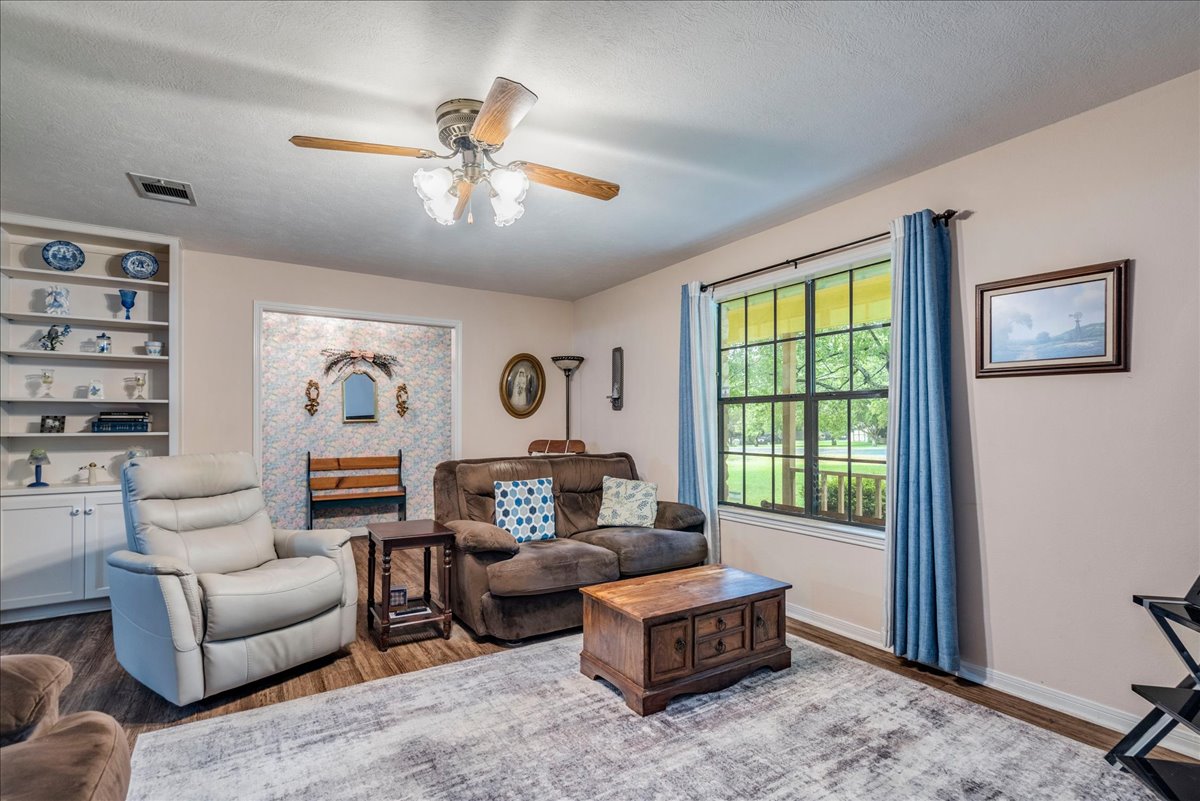 1704 Buttercup Road Pflugerville, TX 78660 - Photo 6 of 37 Relax in this comfortable living area, featuring built-in shelving and views of the surrounding greenery.
