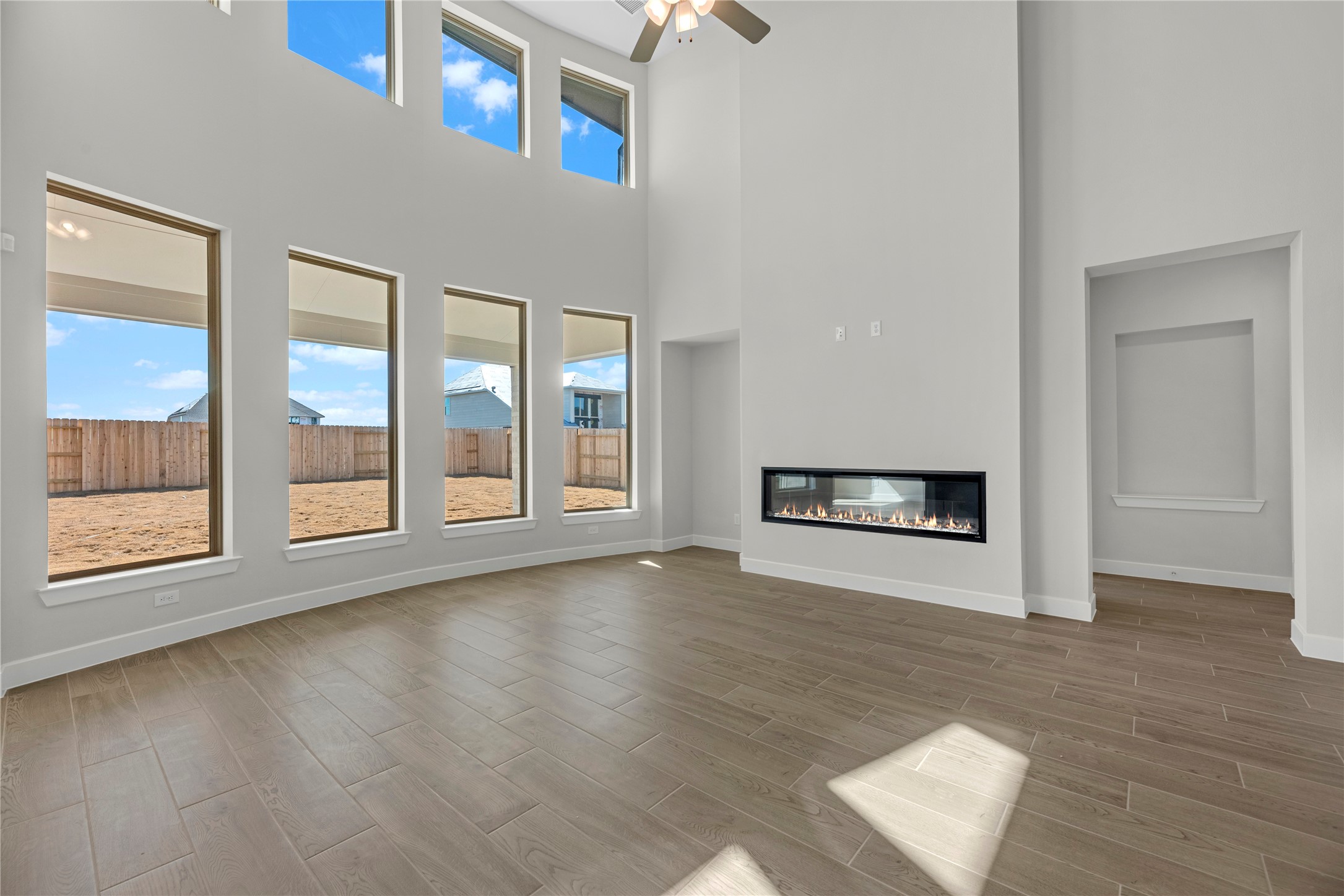 5023 Nesbit Path Rosenberg, TX 77471 - Photo 10 of 25 an empty room with wooden floor and windows