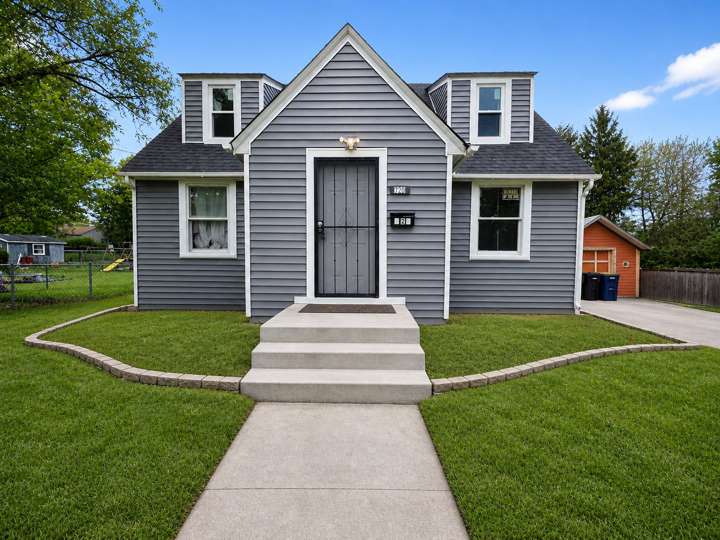 720 Adams Street Elgin, IL 60123 - Photo 1 of 16 a front view of a house with a garden