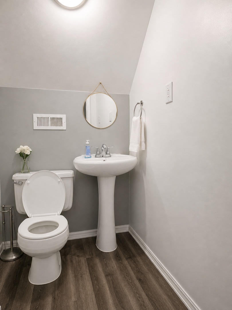 720 Adams Street Elgin, IL 60123 - Photo 11 of 16 a bathroom with a sink toilet and a mirror