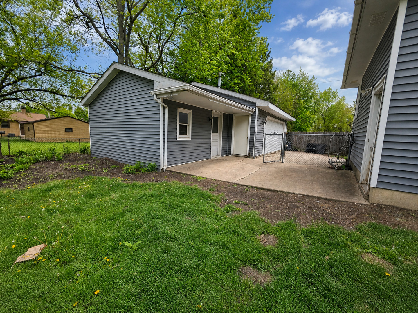 720 Adams Street Elgin, IL 60123 - Photo 16 of 16 a view of a house with yard and a garden