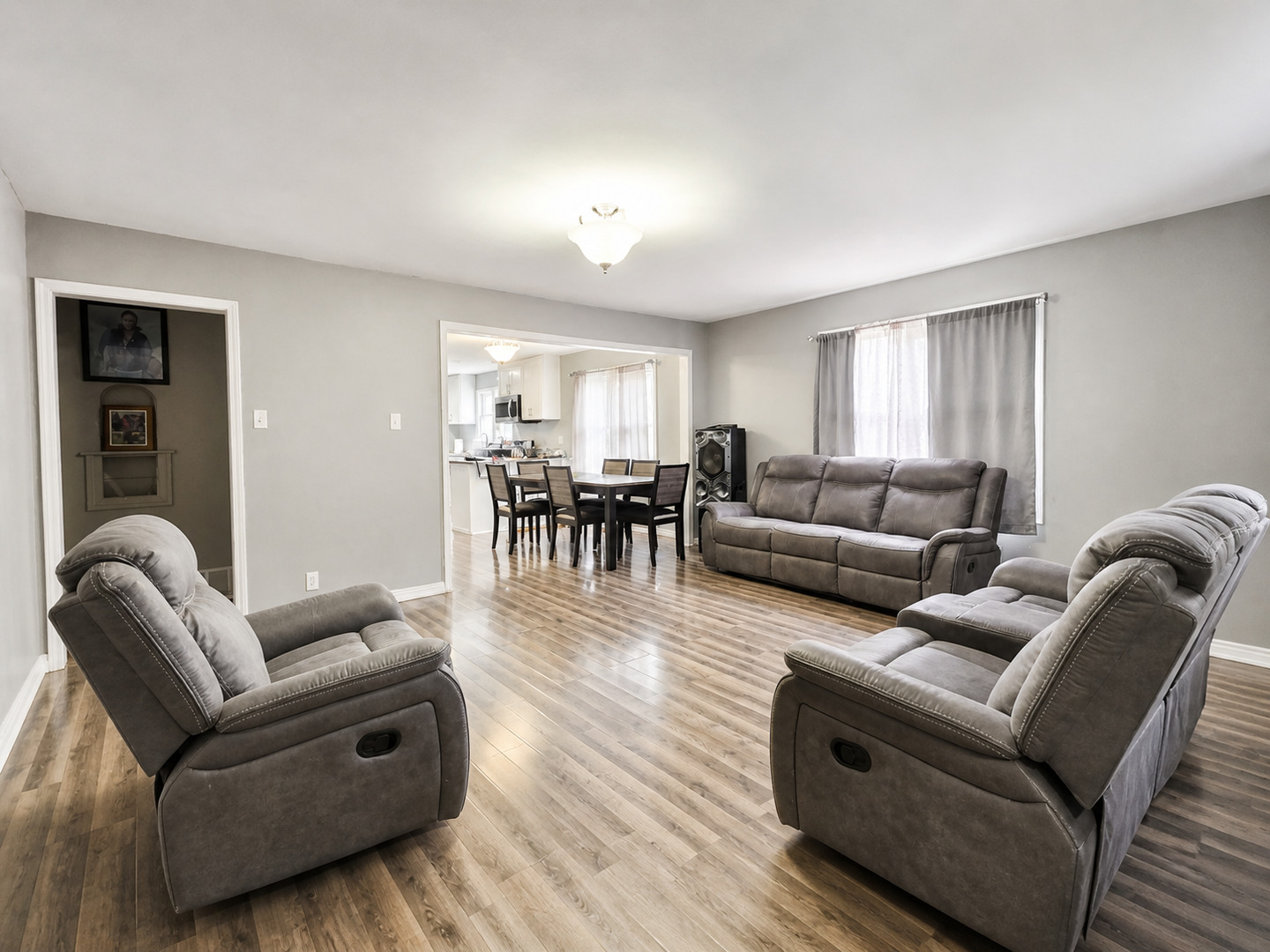 720 Adams Street Elgin, IL 60123 - Photo 2 of 16 a living room with furniture and a dining table with wooden floor