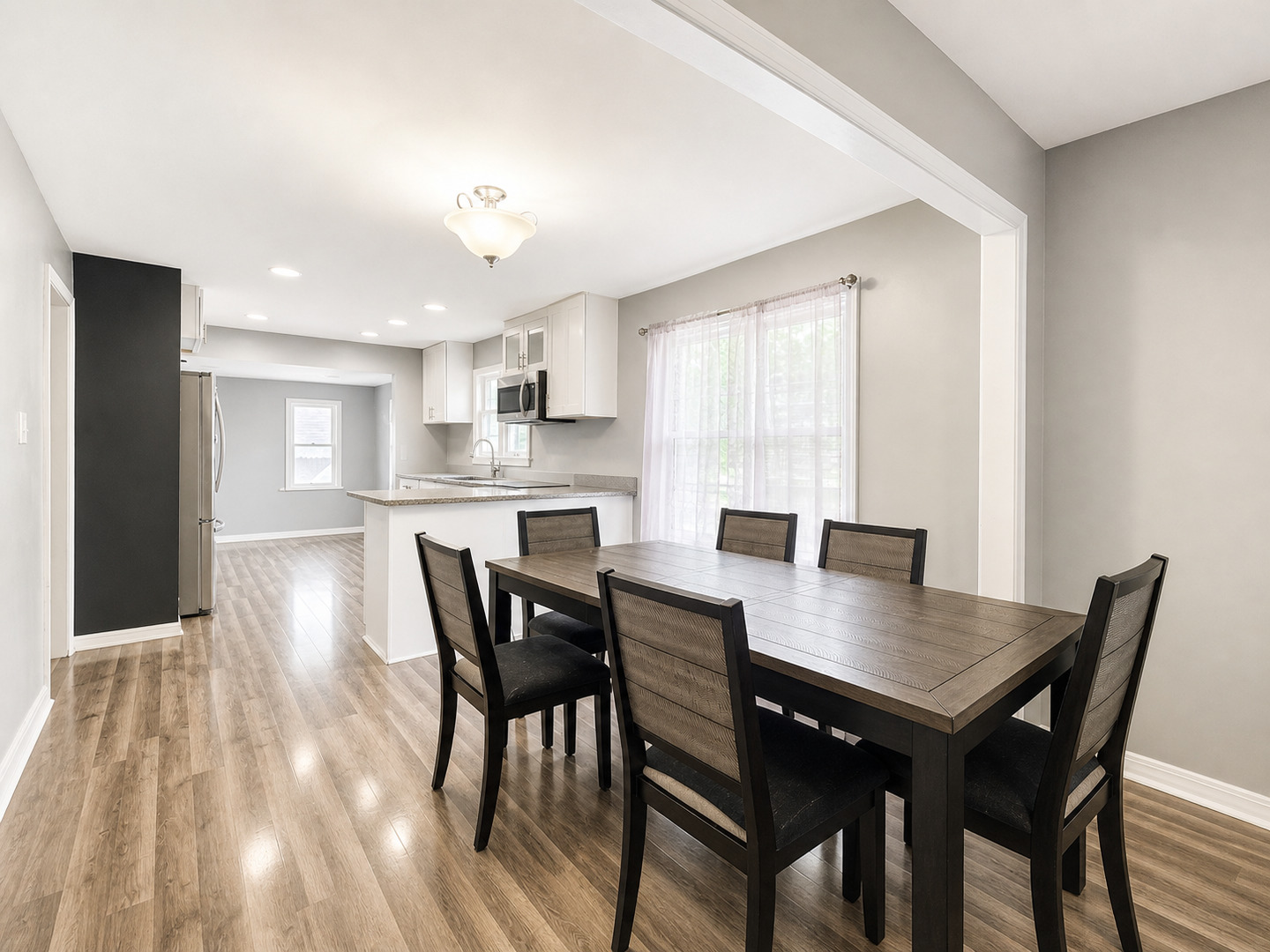 720 Adams Street Elgin, IL 60123 - Photo 3 of 16 a view of a dining room with furniture and wooden floor