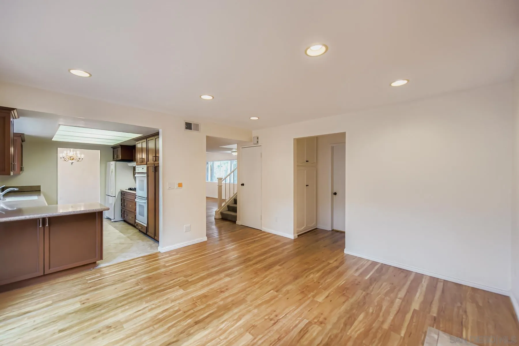 5977 Agee Street San Diego, CA 92122 - Photo 12 of 25 a view of a big room with wooden floor and windows
