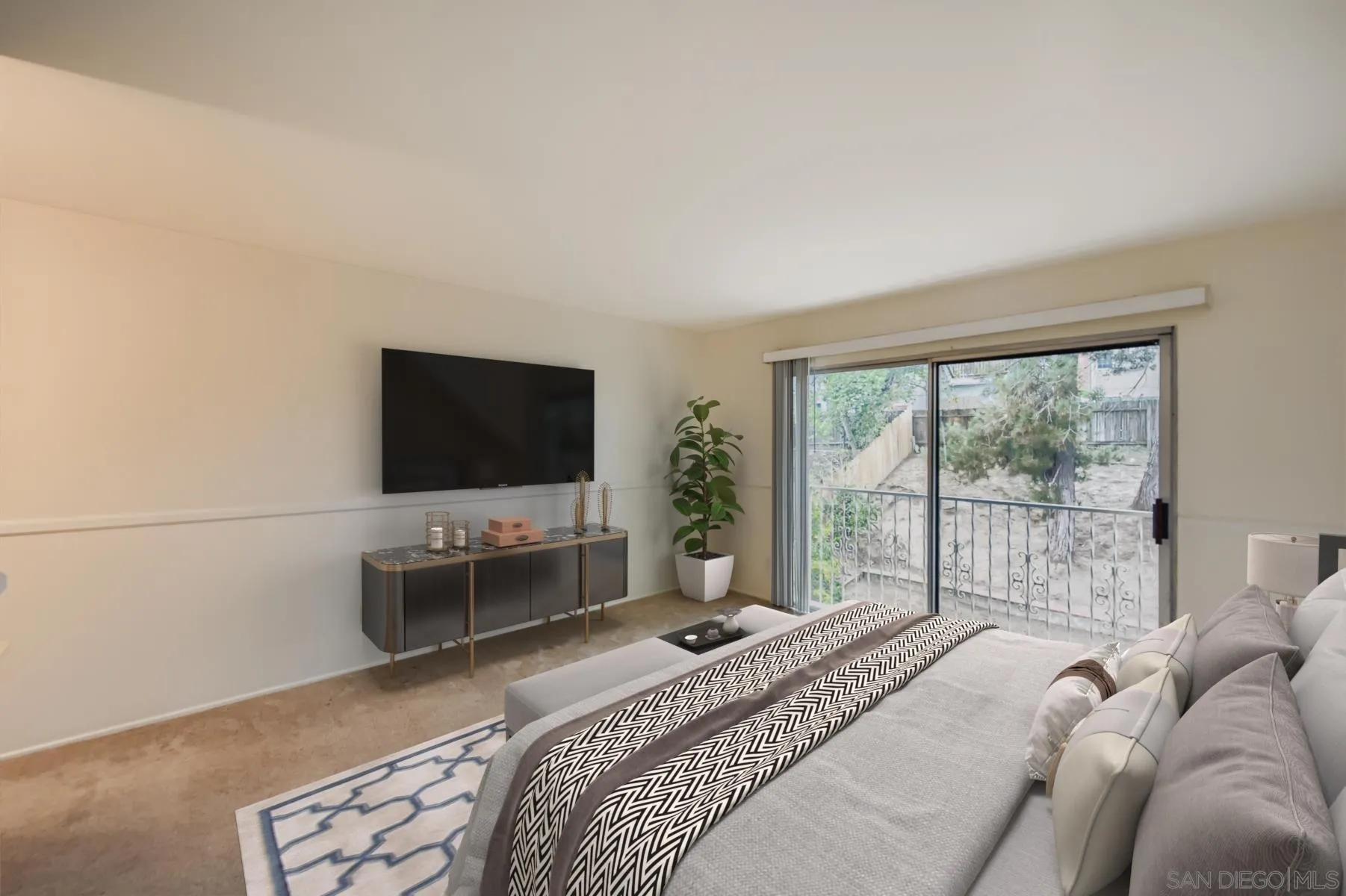 5977 Agee Street San Diego, CA 92122 - Photo 15 of 25 a bedroom with a bed and a flat screen tv