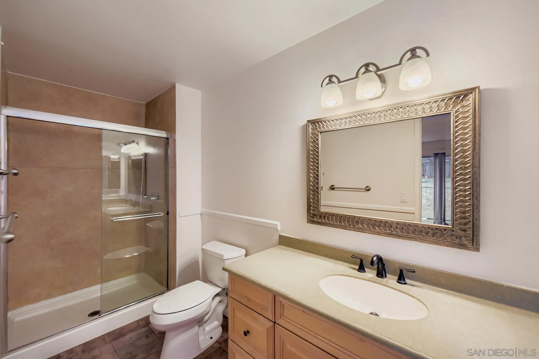 5977 Agee Street San Diego, CA 92122 - Photo 19 of 25 a bathroom with a granite countertop sink toilet and shower