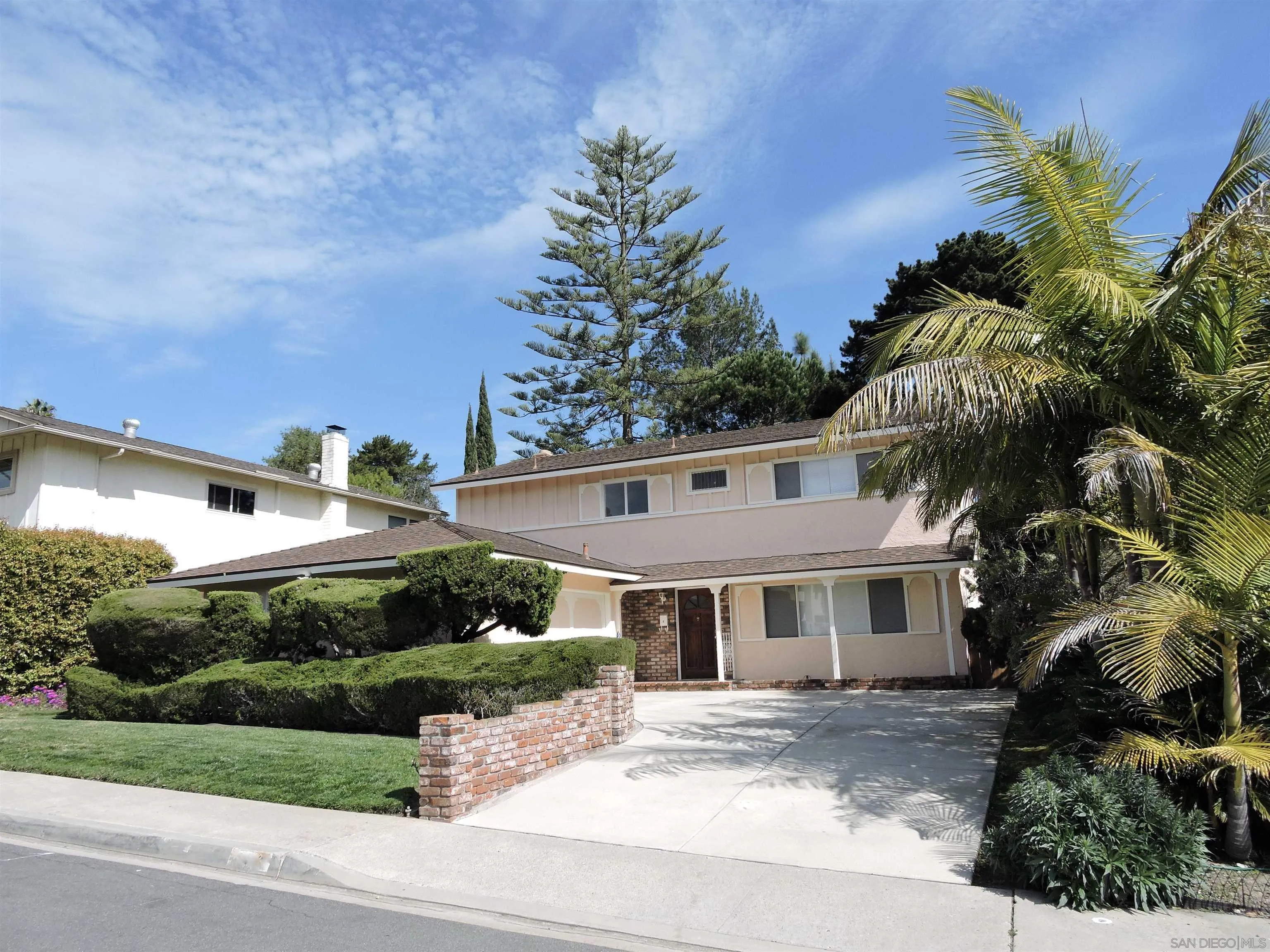 5977 Agee Street San Diego, CA 92122 - Photo 2 of 25 a front view of a house with a garden