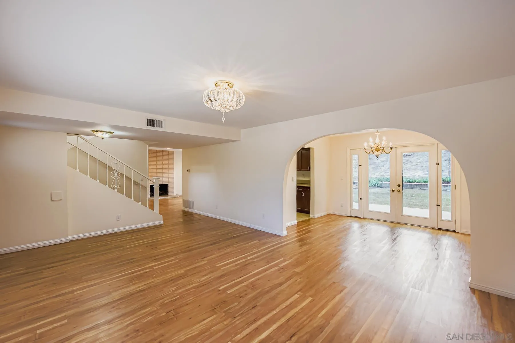 5977 Agee Street San Diego, CA 92122 - Photo 5 of 25 a view of an empty room with wooden floor and a window