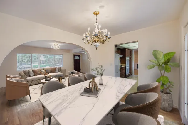 a living room with fireplace furniture and a chandelier