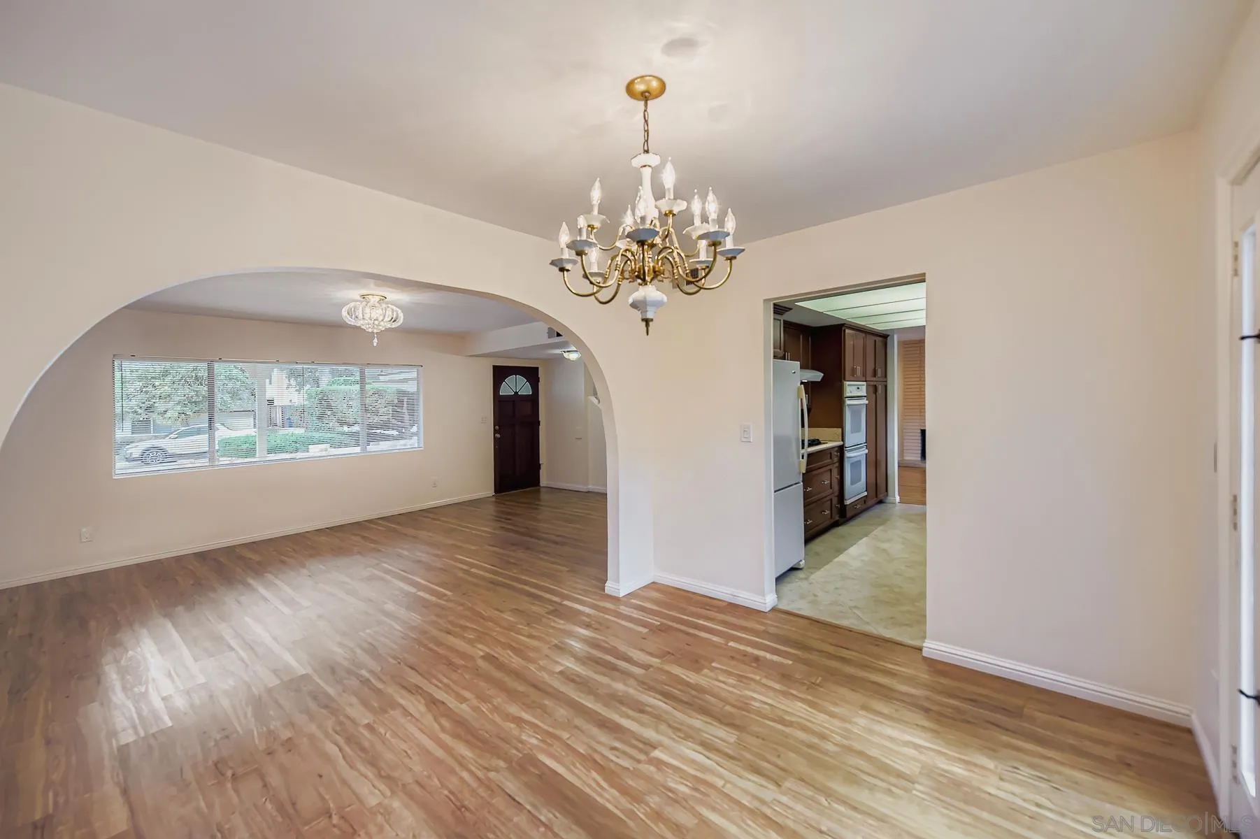 5977 Agee Street San Diego, CA 92122 - Photo 7 of 25 a view of a room with wooden floor chandelier and windows