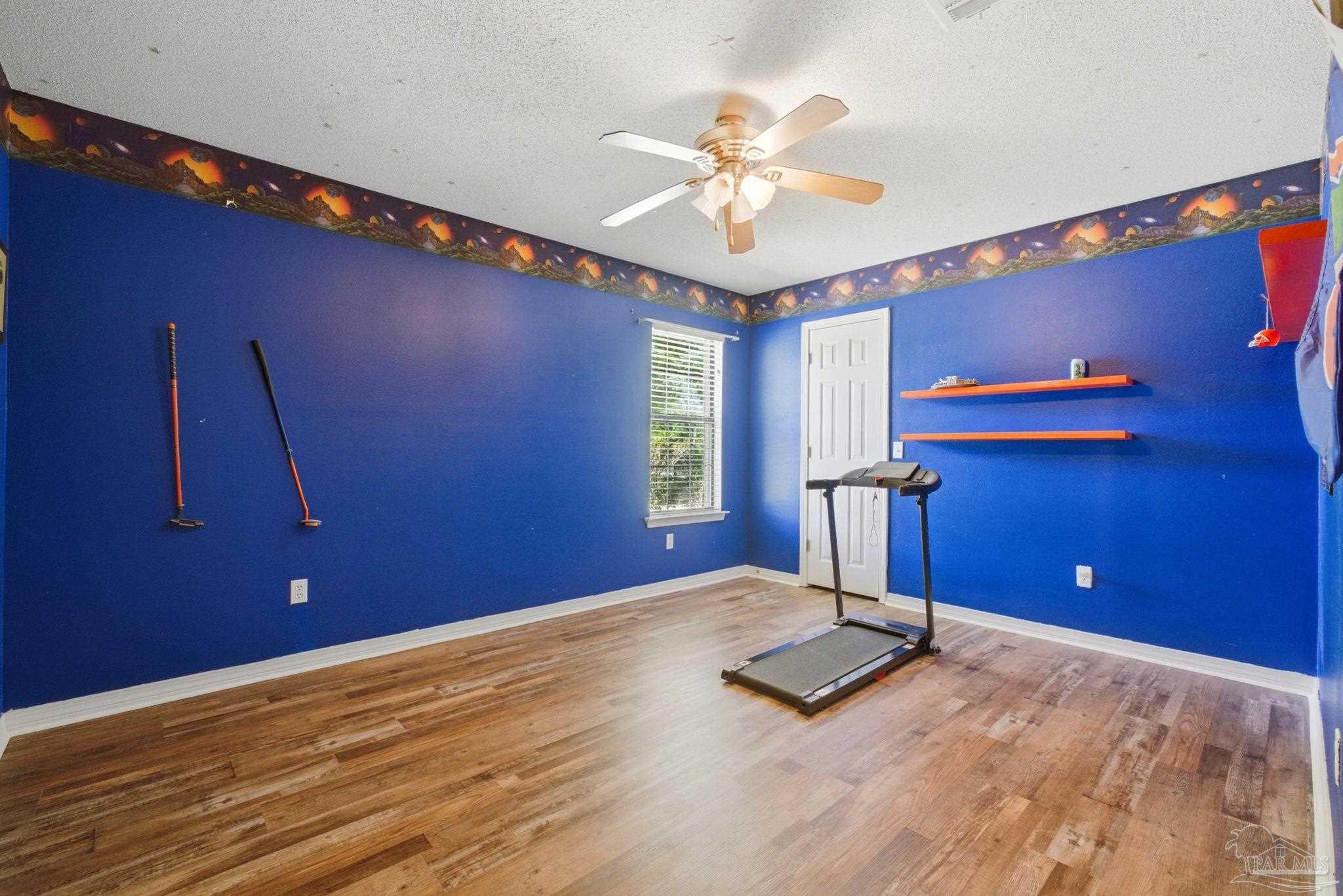 5121 Keyser Mill Road Baker, FL 32531 - Photo 28 of 52 a view of a livingroom with a sofa and ceiling fan