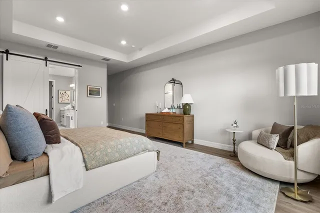 a spacious bedroom with a bed and furniture