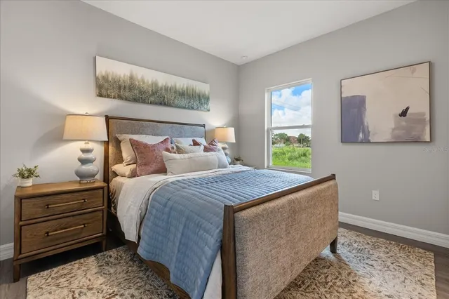 a bedroom with a bed and a painting on the wall