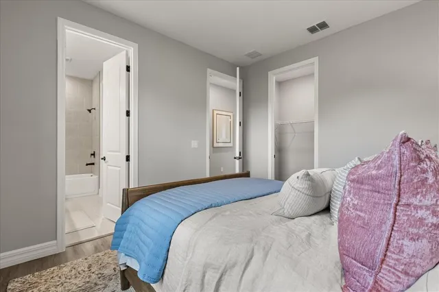 a bedroom with a bed and a dresser