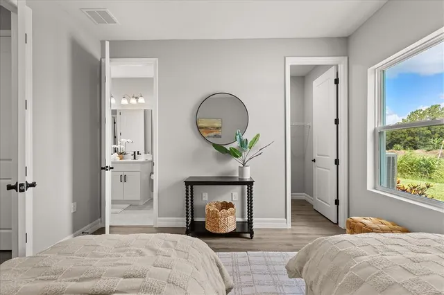 a bedroom with a bed a mirror and a window