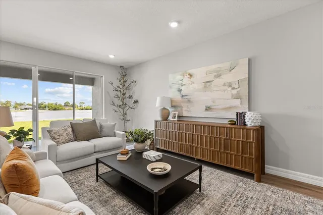 a living room with furniture and wooden floor