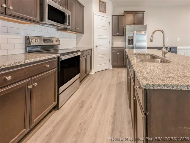 a living room with a fireplace and a wooden floor