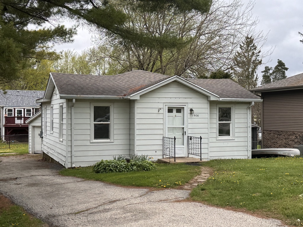 7506 Algonquin Road Wonder Lake, IL 60097 - Photo 2 of 11 a front view of a house with a yard
