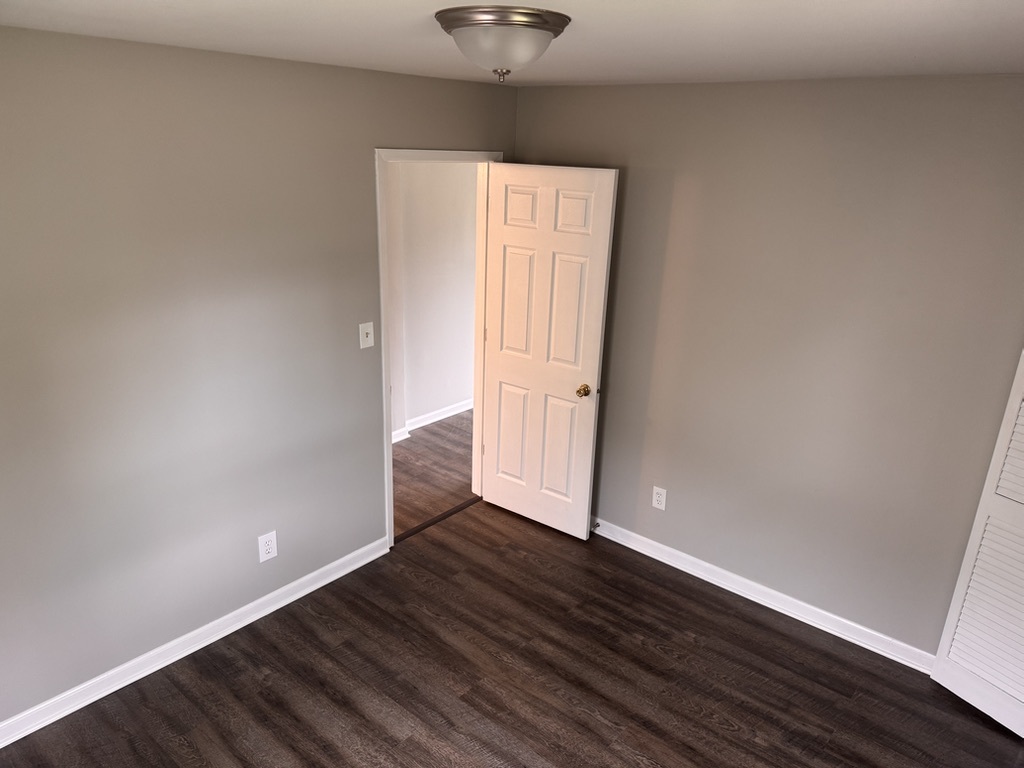 7506 Algonquin Road Wonder Lake, IL 60097 - Photo 6 of 11 an empty room with wooden floor and windows