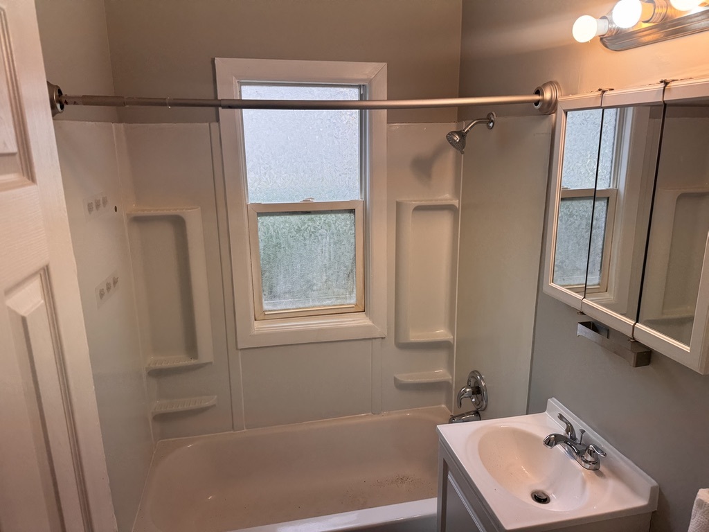 7506 Algonquin Road Wonder Lake, IL 60097 - Photo 8 of 11 a bathroom with a sink a window and a shower