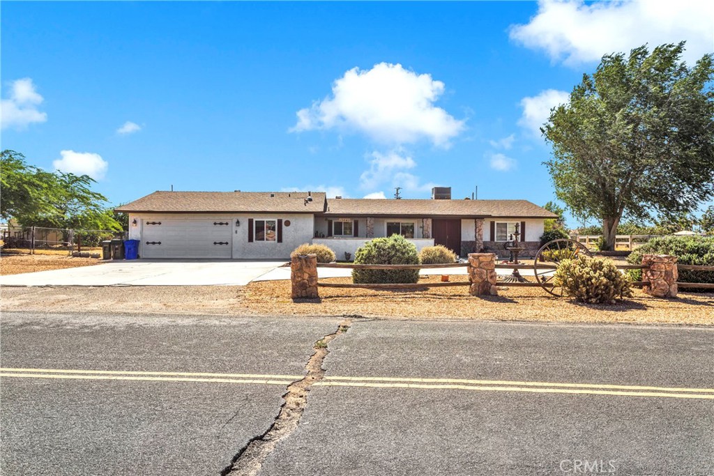 13640 Lakota Road Apple Valley, CA 92308 - Photo 1 of 1 a front view of a house with a yard and garage