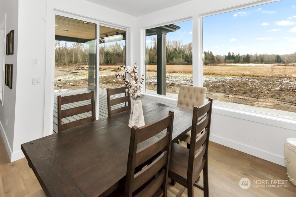 12243 Mundy Loss Road Buckley, WA 98321 - Photo 16 of 40 a dining room with furniture and a floor to ceiling window