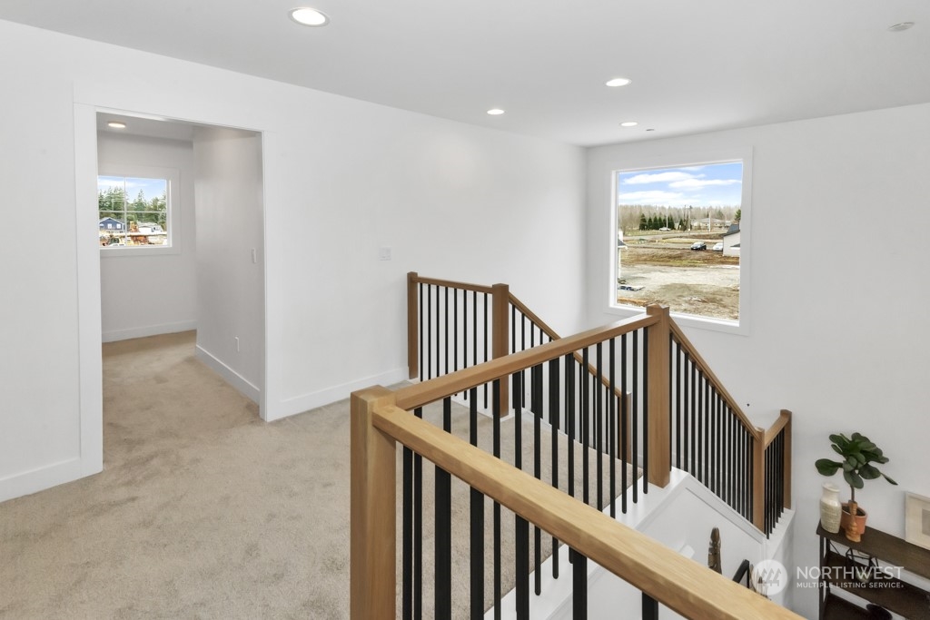 12243 Mundy Loss Road Buckley, WA 98321 - Photo 31 of 40 a view of staircase with railing and white walls