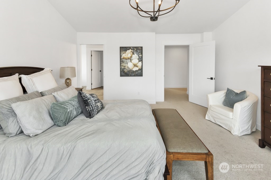 12243 Mundy Loss Road Buckley, WA 98321 - Photo 32 of 40 a bedroom with a bed and a chandelier