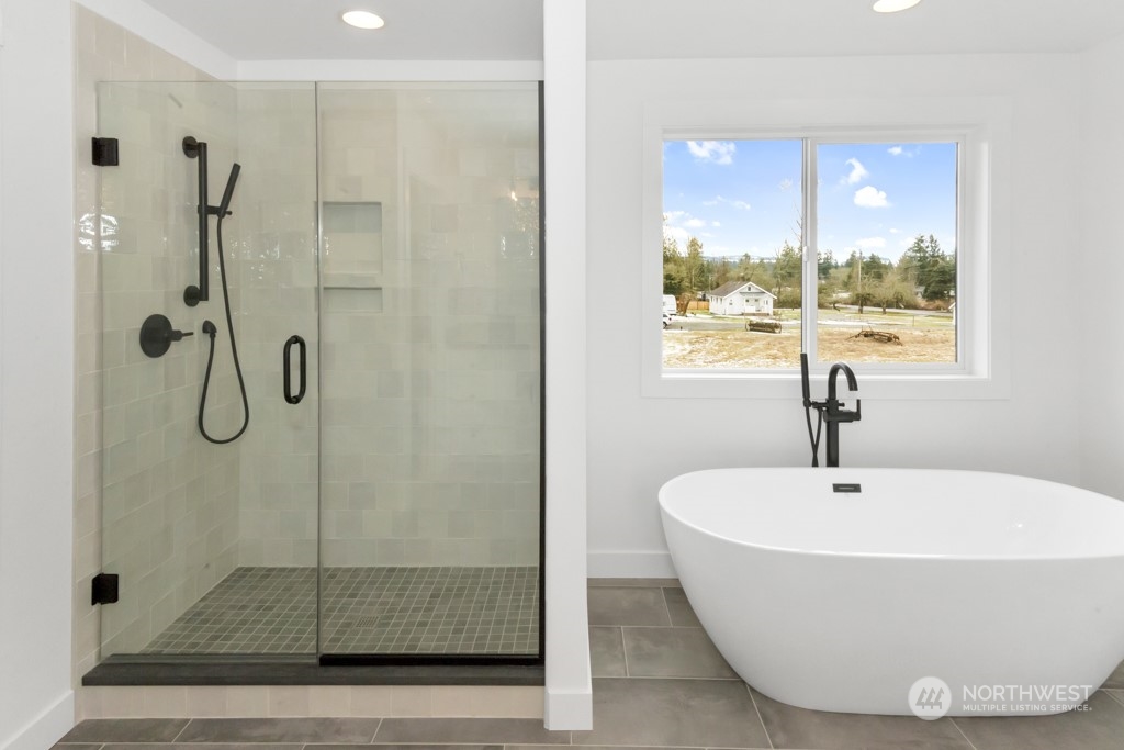 12243 Mundy Loss Road Buckley, WA 98321 - Photo 36 of 40 a bathroom with a bathtub and a shower