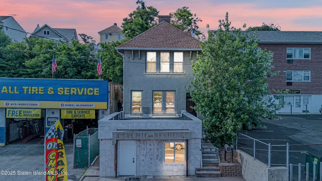 a front view of a house with plants
