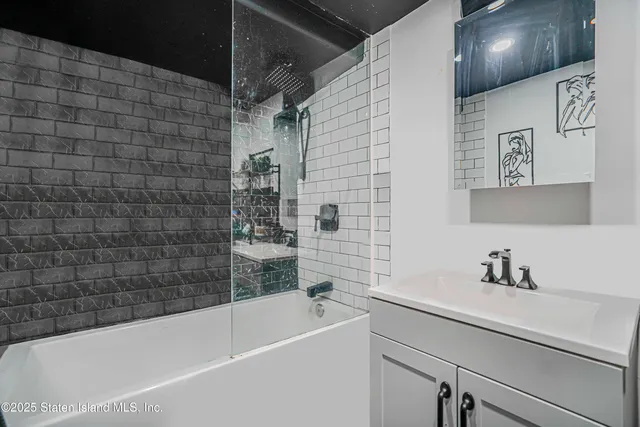 a bathroom with a sink a bathtub and shower