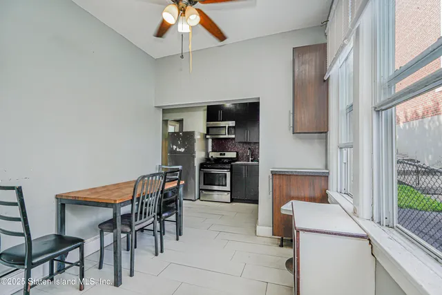 a kitchen with a dining table and chairs