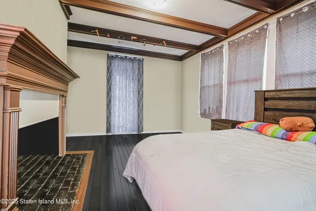 a bedroom with a bed and a fireplace