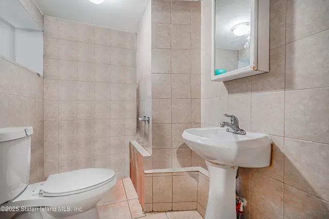 a bathroom with a sink toilet and mirror