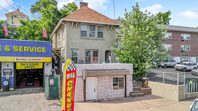 a front view of a multi story building with retail shops