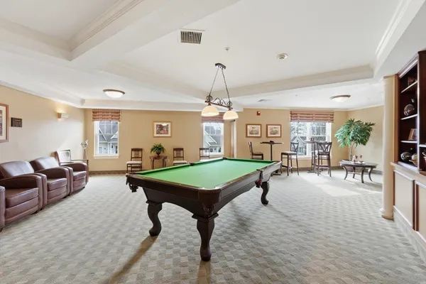 a room with lots of furniture and a chandelier