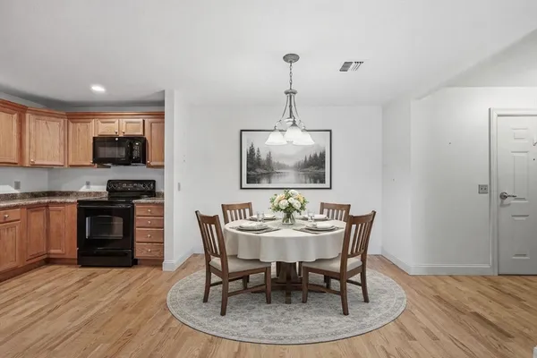 a dining room with furniture and wooden floor