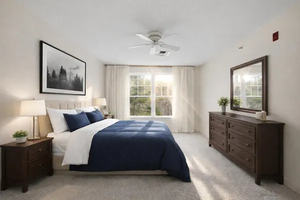 a spacious bedroom with a large bed and a window