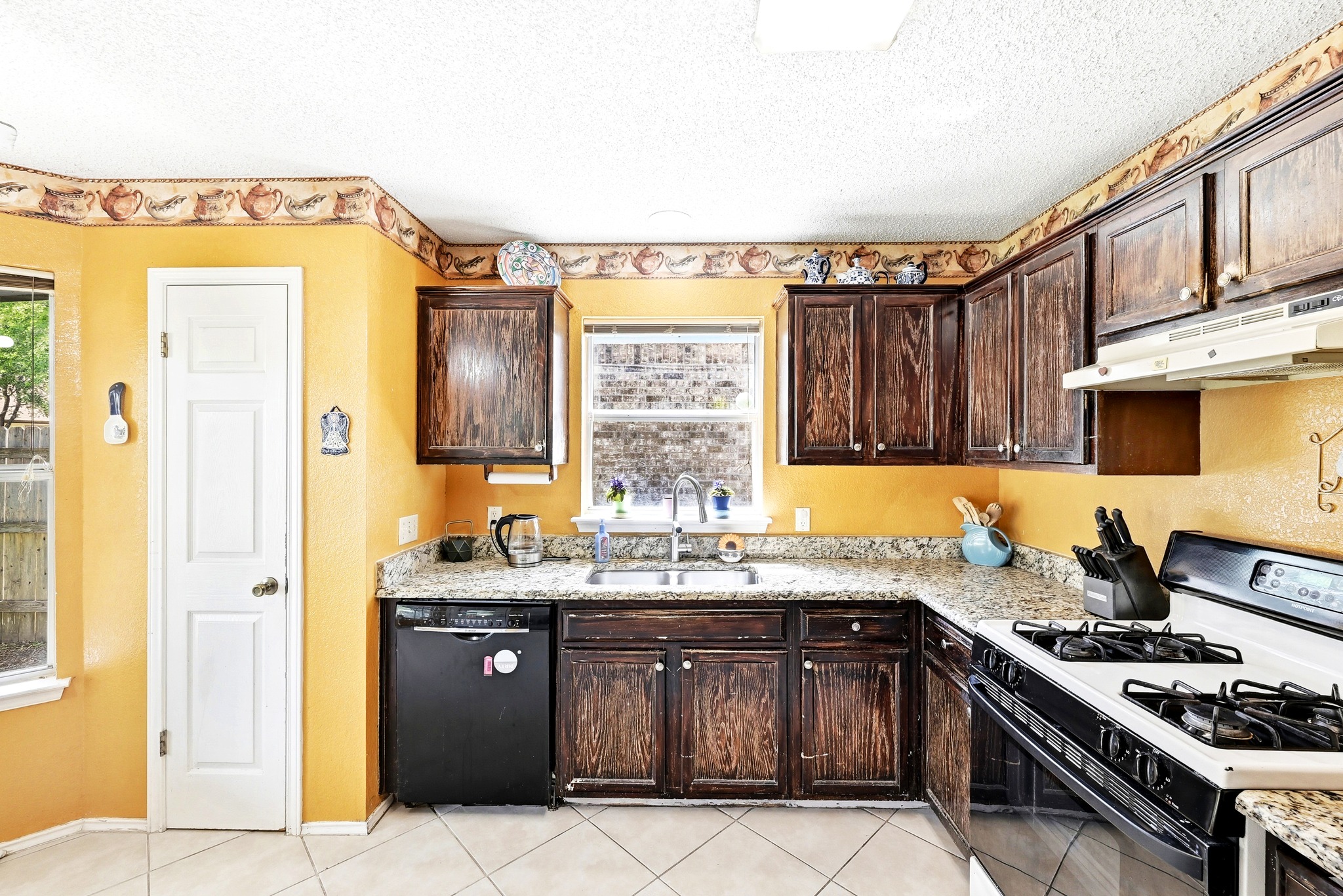 6412 Colton-Bluff Springs Road Austin, TX 78744 - Photo 13 of 27 Functional kitchen with ample cabinet space and a practical layout awaits culinary endeavors.