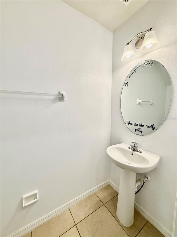 14207 Poke Ridge Drive Riverview, FL 33579 - Photo 13 of 34 a bathroom with a sink a mirror and toilet
