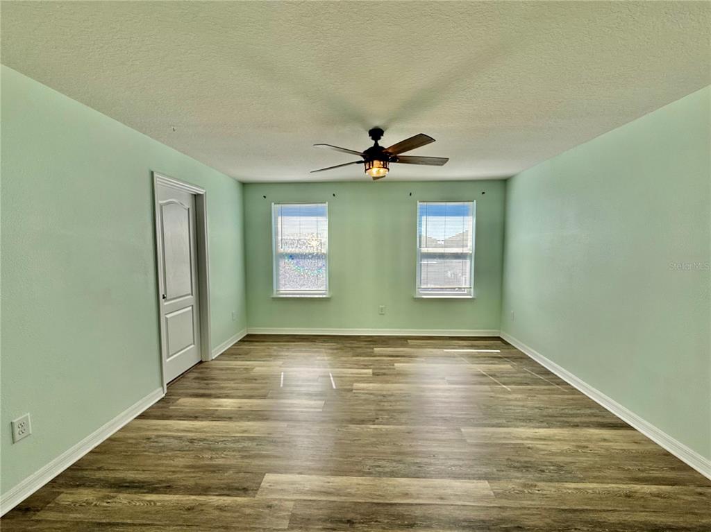 14207 Poke Ridge Drive Riverview, FL 33579 - Photo 16 of 34 a view of an empty room with window and wooden floor